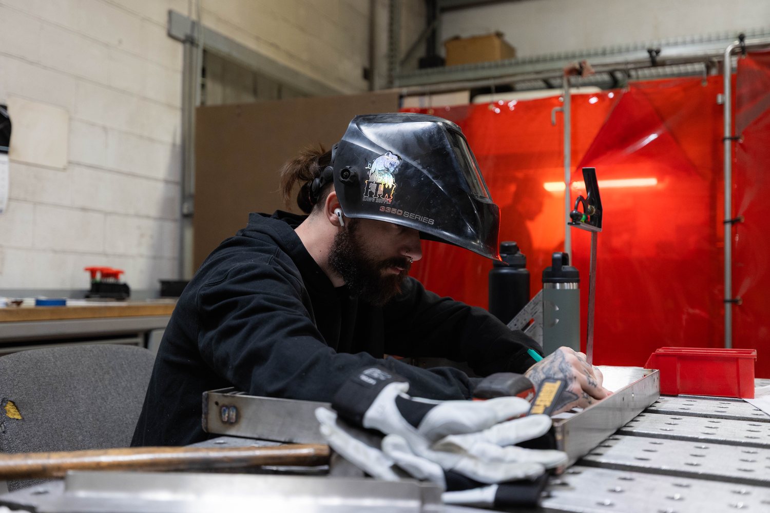 An STI welder welding a part at a fabrication fixture