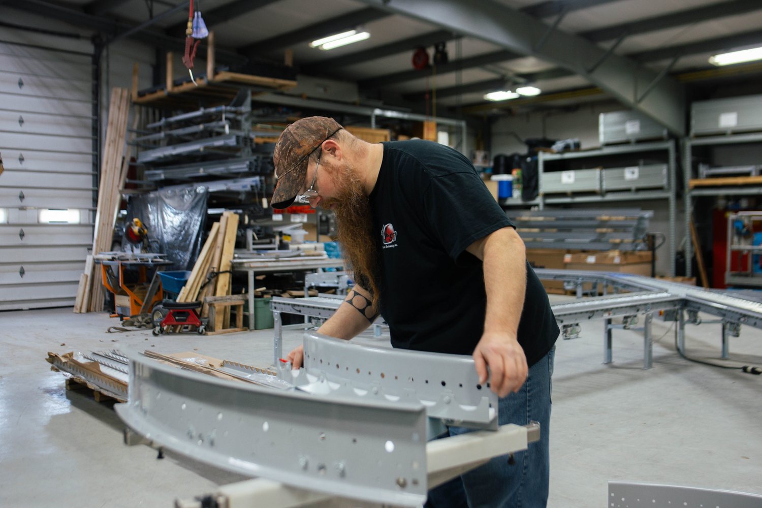 An STI technician assembling a stainless conveyor frame