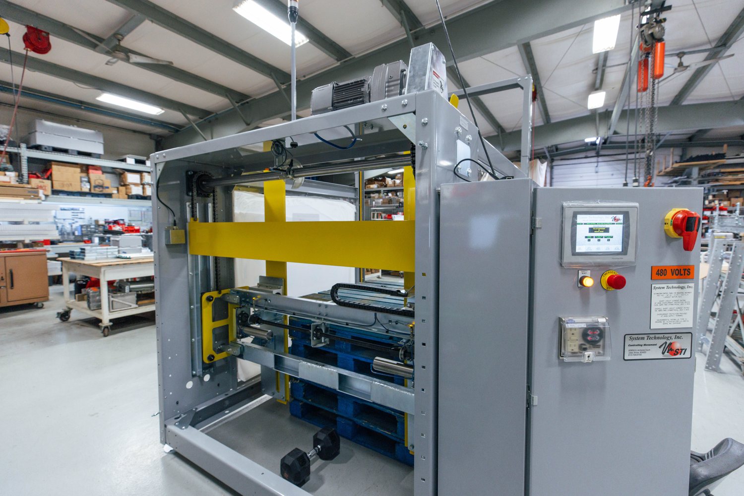 A completed System Technology conveyor system and control panel on the shop floor
